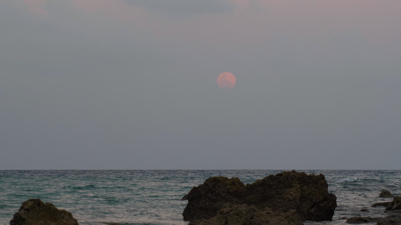 red blood moon rise up over indian beach in andaman islands, timelapse
