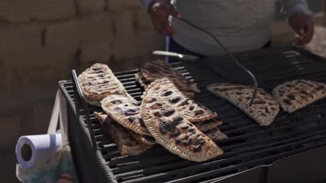 A-traditional-process-of-making-tortillas-on-a-grill,-showcasing-the-rich-cultural-heritage-and-culinary-expertise-of-the-northern-Argentine-region