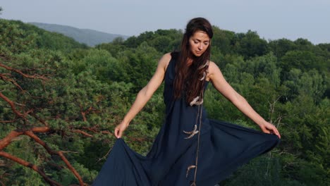 wild woman waves dress, looks at sun. lady is seen in a dress flying gown fluttering in wind