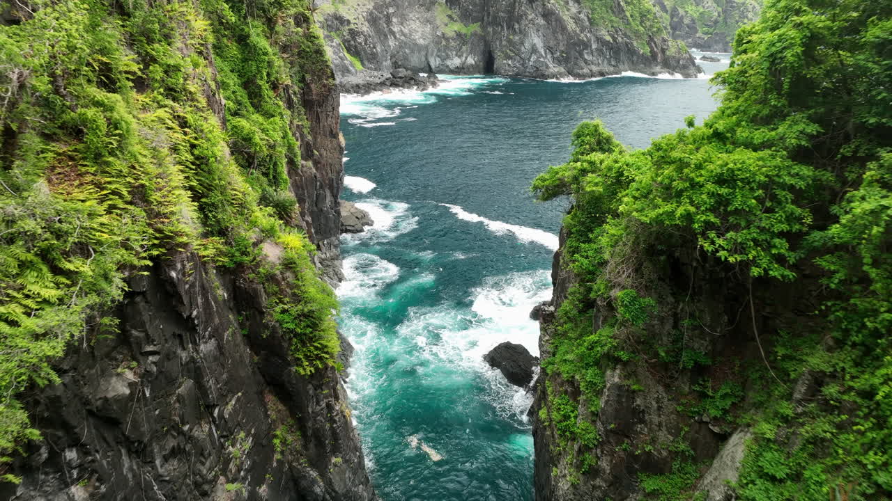 Aerial views through valley of Orong Bukal cliff jumping location on Lombok Island, Indonesia