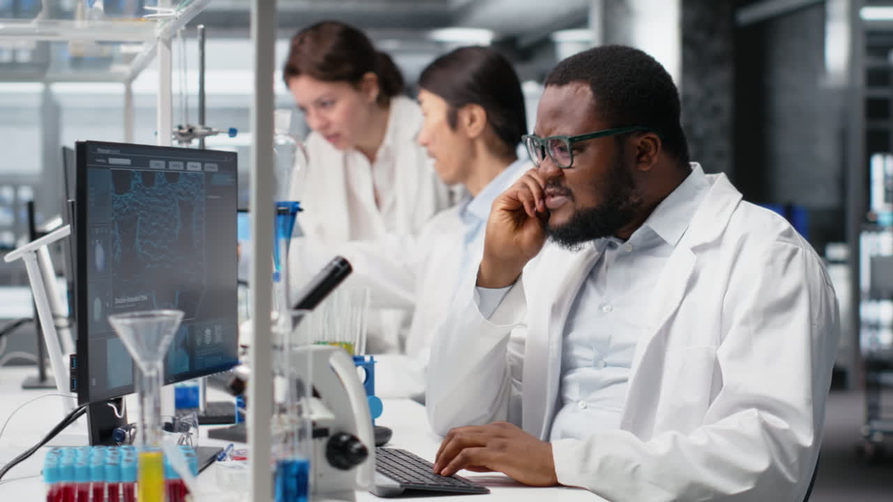 Vertical video Stressed lab scientist using computer monitor, processing DNA patient data