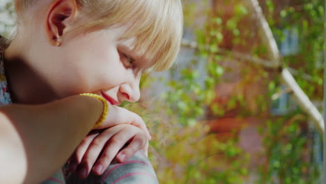 a 6 year old girl in sunglasses looks out the window 1