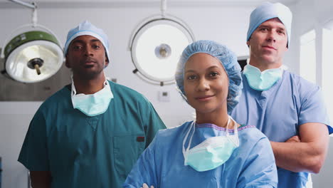 portrait of multi-cultural surgical team standing in hospital operating theater