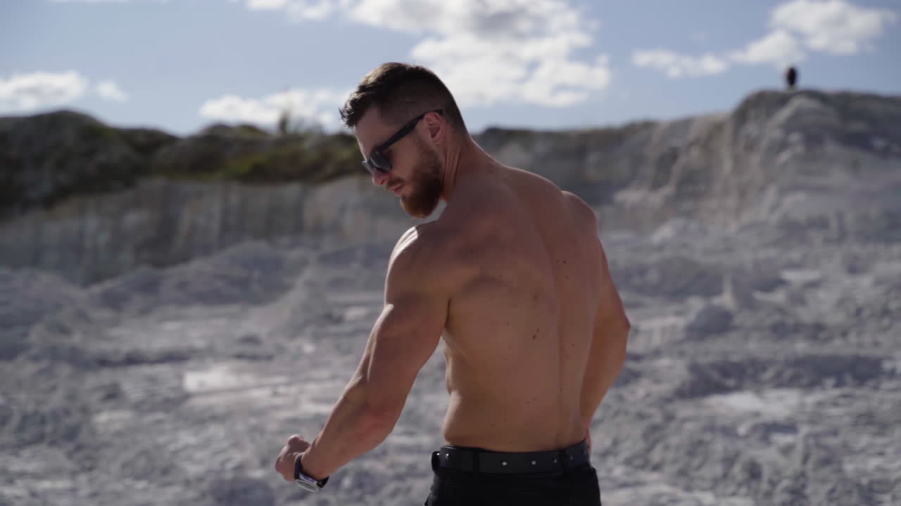 Sexy man posing outdoor. Shirtless young bodybuilder posing on nature