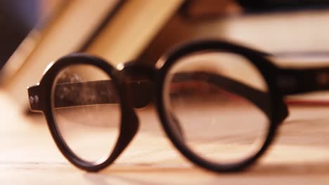 various books with spectacles on a desk