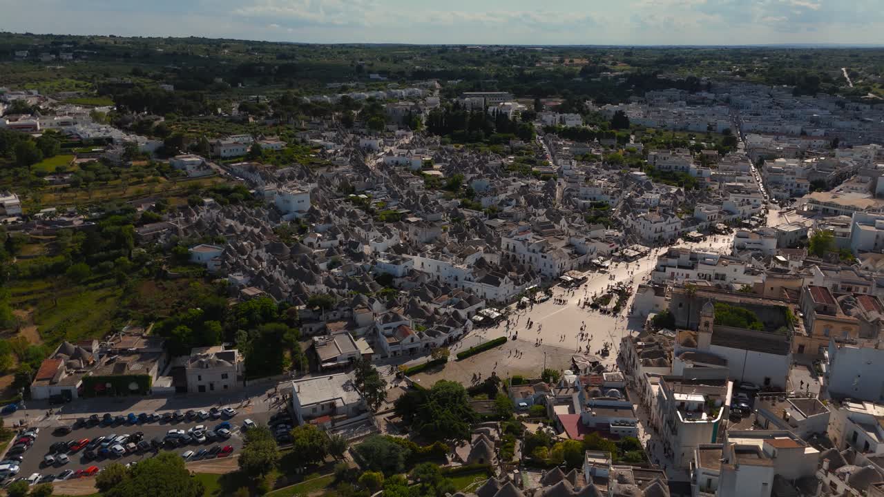 Trulli rooftops forming geometric patterns in historic UNESCO Alberobello old town, Italy. Aerial view