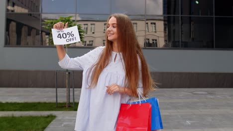 cheerful girl showing up to 40 percent off text advertisement. online shopping with low prices