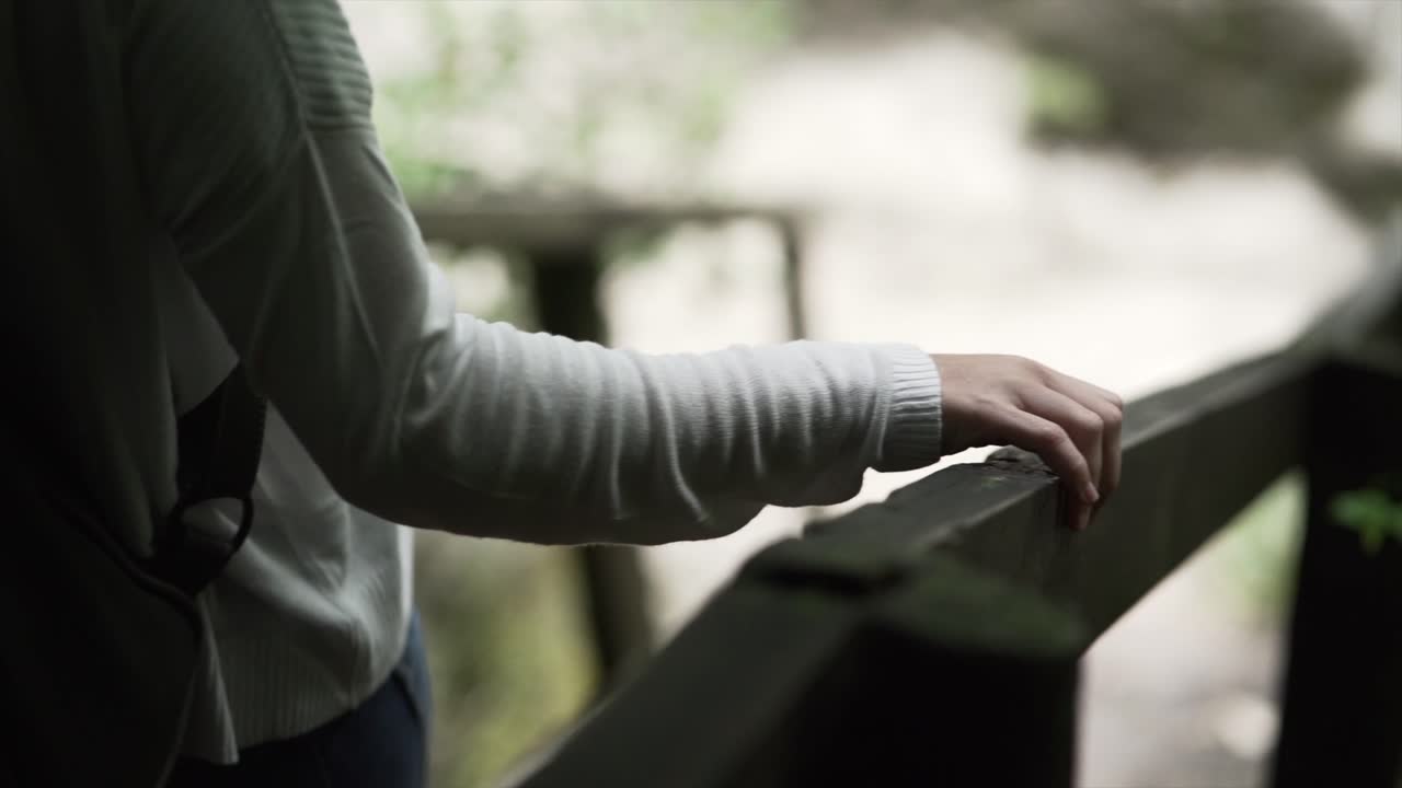 Hand on a Wooden Railing