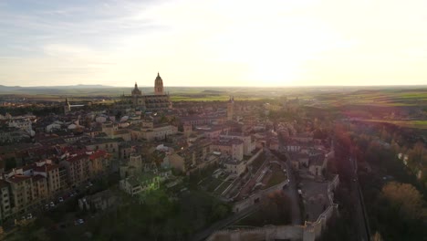 aerial dolly out 4k view revealing the european famous city of segovia in spain at sunset