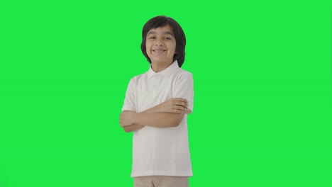 Portrait-of-Happy-Indian-boy-standing-crossed-hands-Green-screen