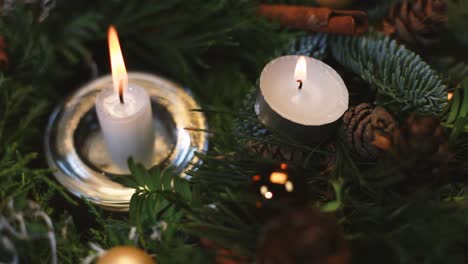 the woman lights a candle on an advent wreath, the background slightly blurred