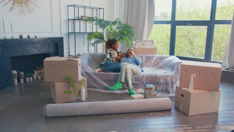 young multiracial couple from woman and man have moved into new house