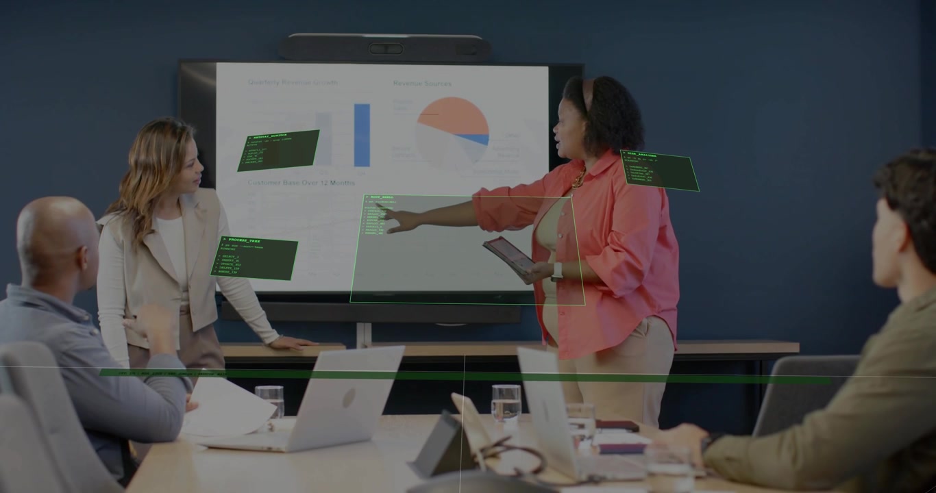 Tapping tablet coral shirt presenter starting HUD at meeting room screen, showing data, copy space