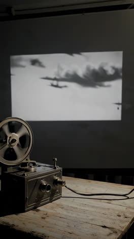 vintage film projector showing a black and white war scene