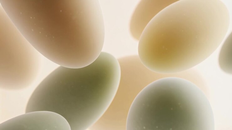 Drifting ovals separating and rotating in closeup, backlight revealing depth with specks