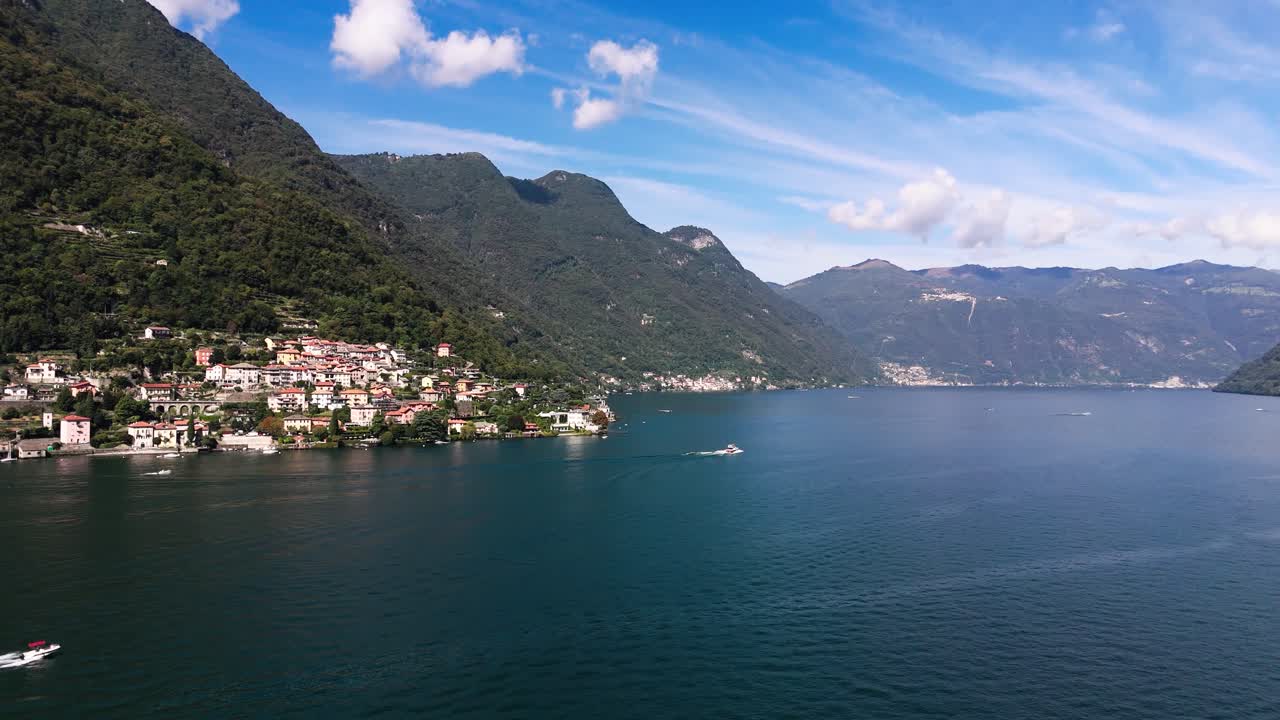 Drone view of Lake Como, boats and some houses, Italy
