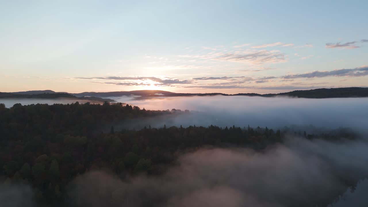 epic arial sunrise drone fly above the clouds in a foggy dreamy misty mountains landscape revealing beauty of Mother Earth