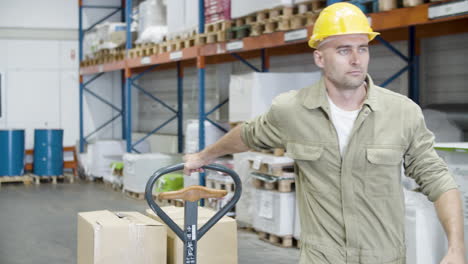 serious male worker pulling trolley with cardboard boxes