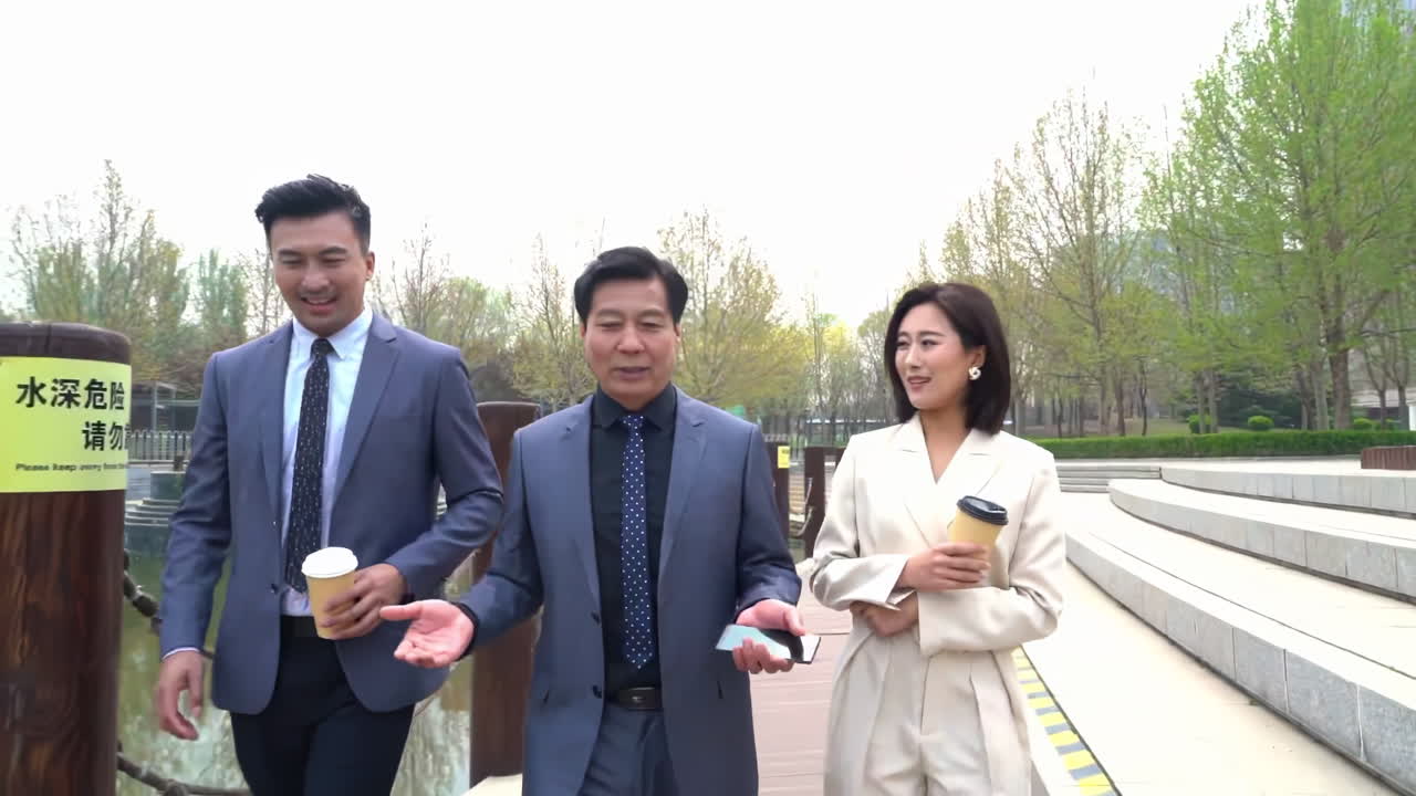 Brainstorming new ideas creative team. Business professionals walking and discussing outside a modern city office building, collaborating on work .