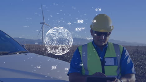 engineer using a tablet with a wind turbine and a digital globe