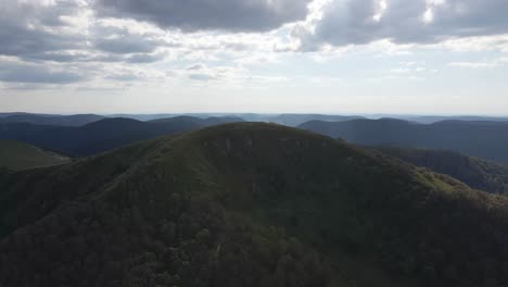 aerial shot over a mound and a mountainous landscape. vosges, france, summit of the kastelberg