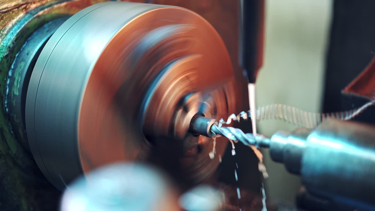 Close-up process of cutting metal in lathe machine in the factory. Lathe grinding machine metalworking industry concept