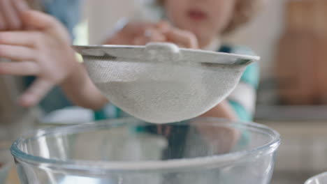 little boy helping mother bake in kitchen mixing ingredients sifting flour using sieve preparing recipe for cupcakes at home