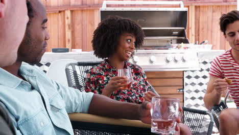 young adult friends talking on the porch outside a house