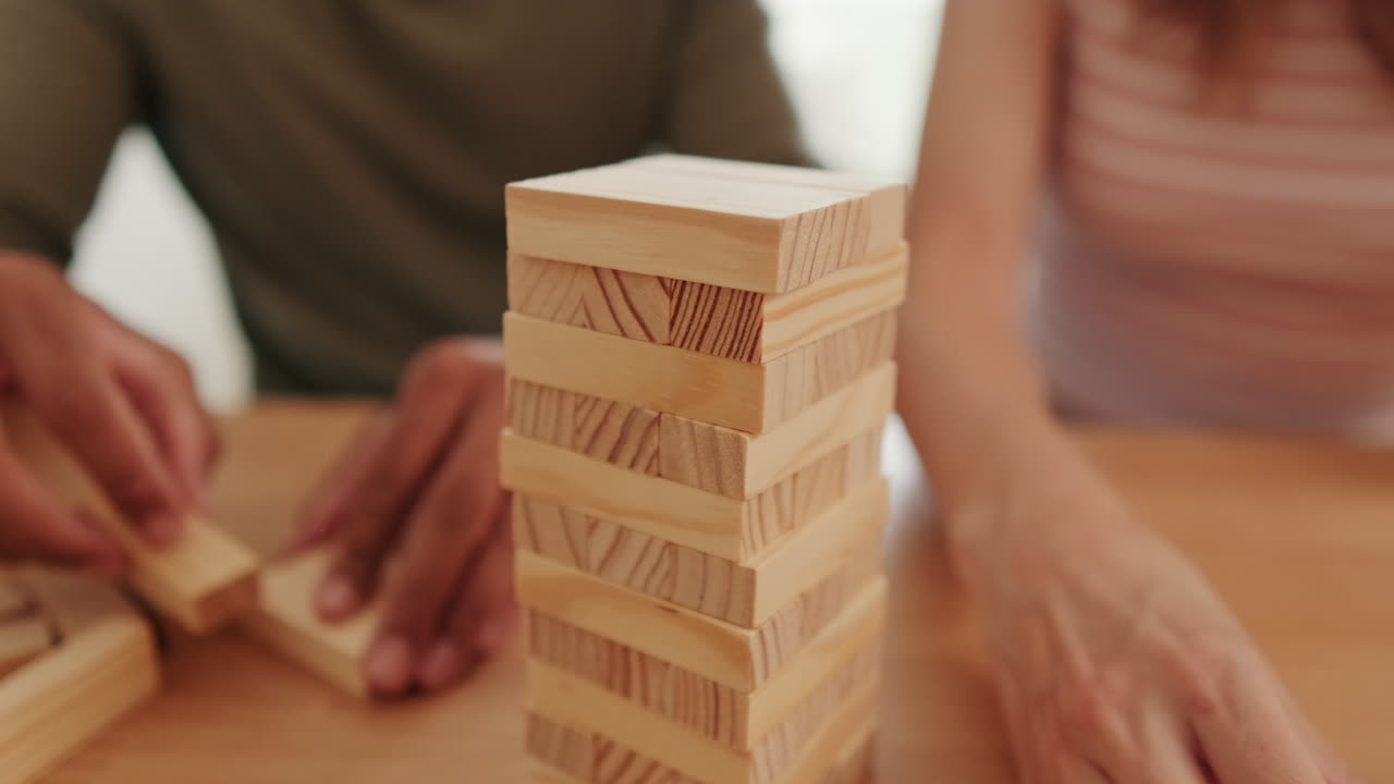 Couple Having Fun Playing Jenga at Home