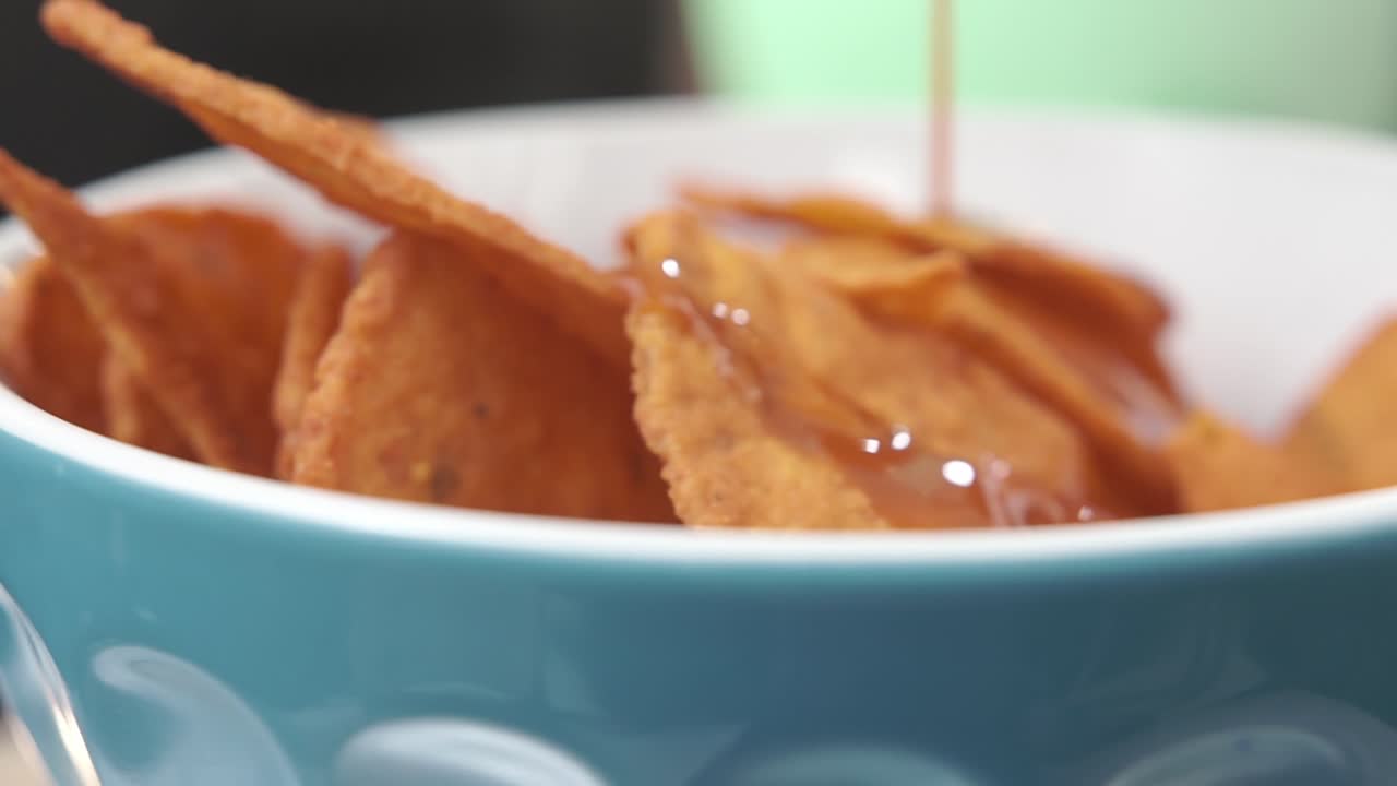 Tasty tortilla chips in a blue bowl create a cozy, snack-time feel