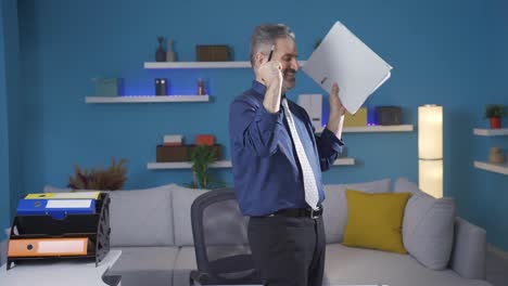 the old businessman working in his home office finds the document he is looking for, his mood rises.
