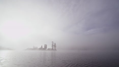 foggy dramatic scene looking across swan lake in montana