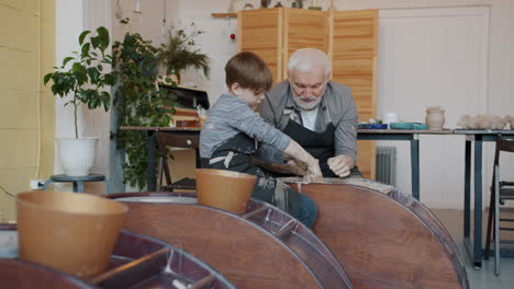 grandfather and grandson making pottery