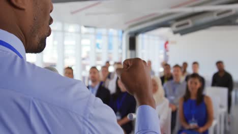 male speaker addressing the audience at a business seminar