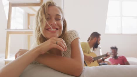 Beautiful-woman-smiling-while-sitting-on-the-couch