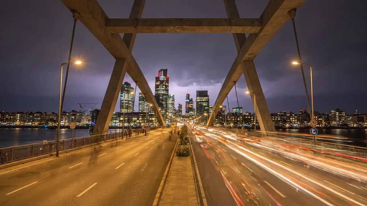 Dramatic Lightning Strikes Over Urban Cityscape at Dusk, Capturing Vibrant Lights and Motion in Modern Architecture Along the Riverbank