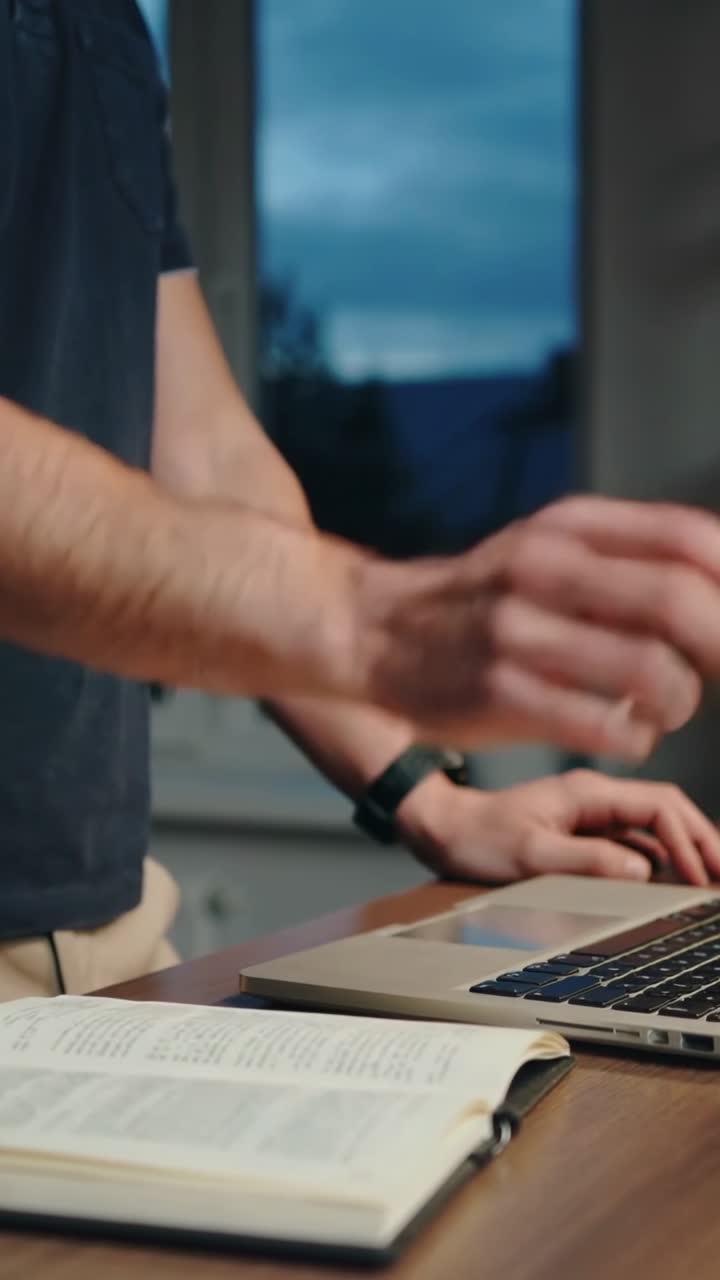 Mani di una persona che digitano e chiudono un portatile su una scrivania