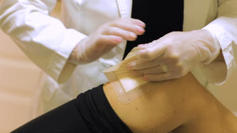 doctor checking a patient's knee wound