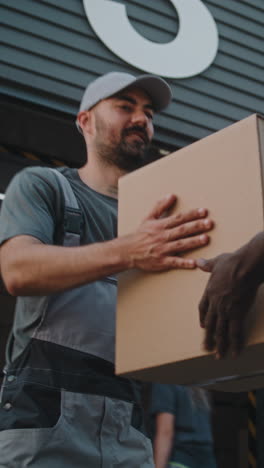 delivery person handling packages at a logistics hub