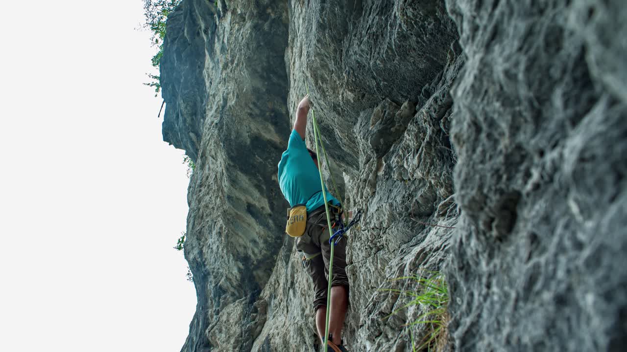 Young strong Caucasian man lead rock climbing, Burjakove peci, Slovenia