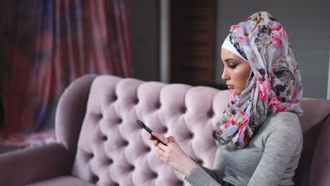 young muslim woman using smartphone
