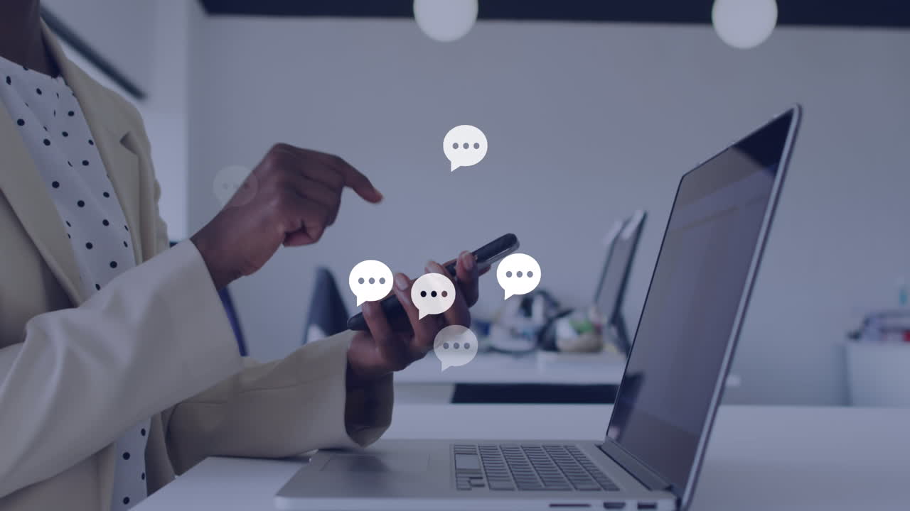 Animation of message icons over mid section of a african american woman using smartphone at office