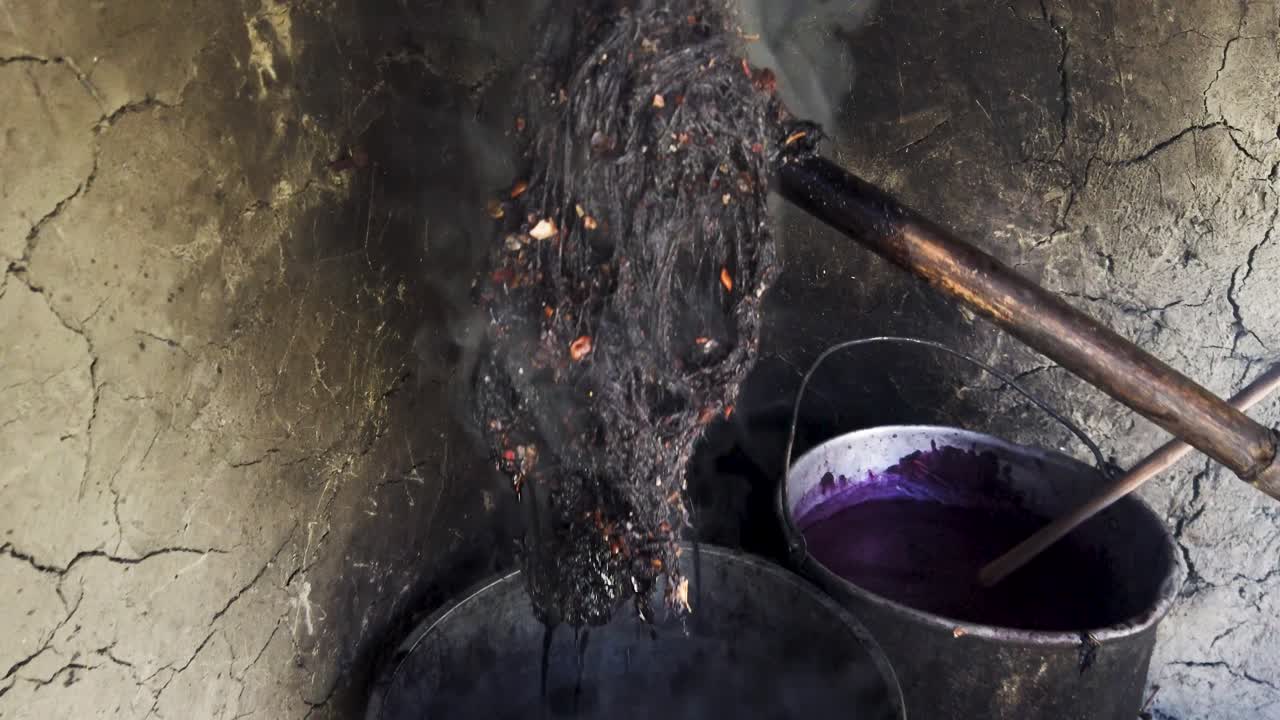 Close up view of naturally dyed wool in a rustic Quechua village home. Natural alpaca wool dyeing process in the Sacred Valley of Cusco, Peru