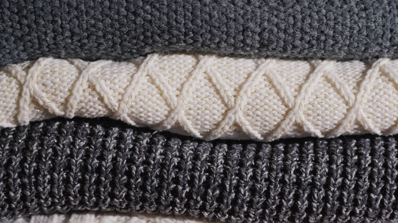 Warm knitted clothes, lying neatly stacked on the shelf