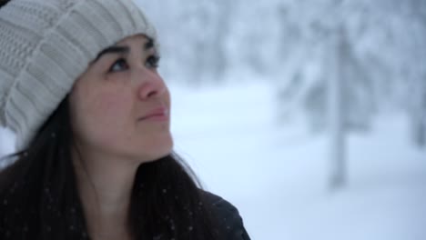 Girl-Explores-Up-At-Trees-In-Snowy-Winter-Wonderland-In-Lapland,-Finland,-Arctic-Circle