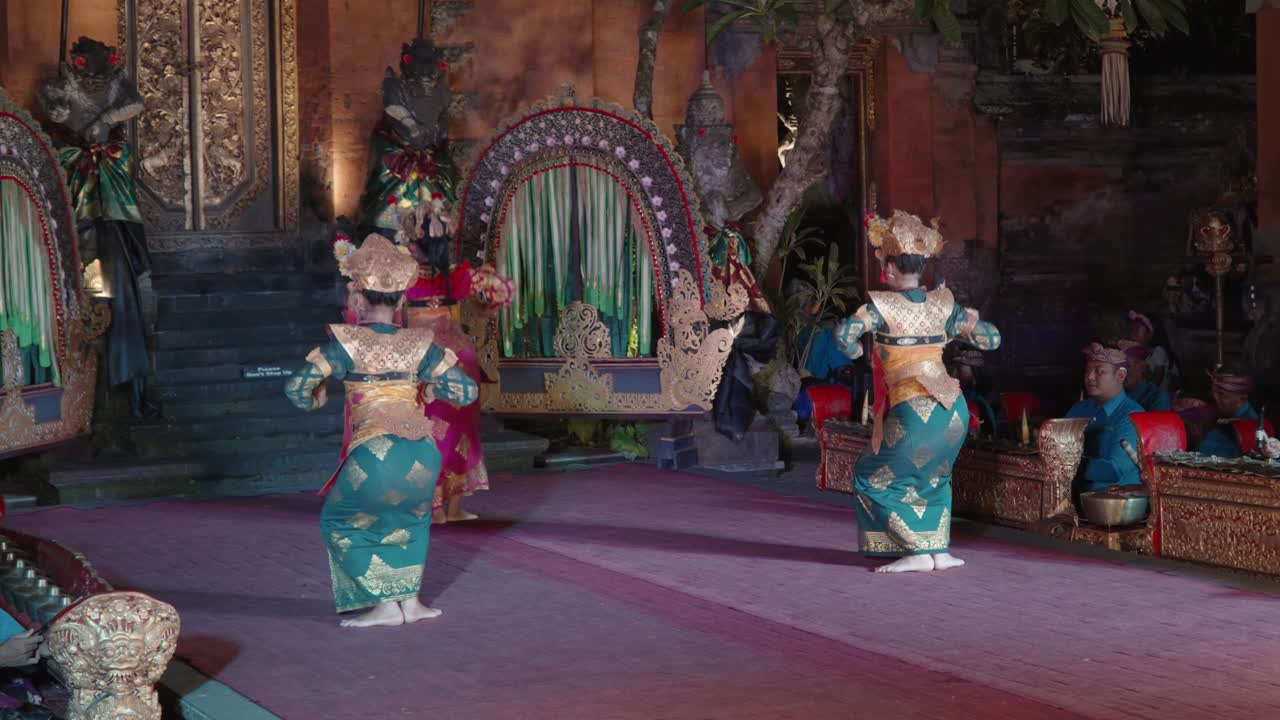 Two Balinese Woman Dancers With Fans in Traditional Costumes Perform Legong Dance Performance Held at Ubud Palace, Bali