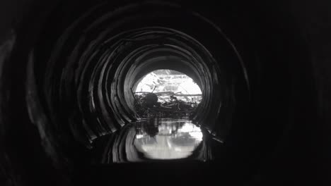 damaged concrete drainage pipe, collector of city sewage system, view fron inside.