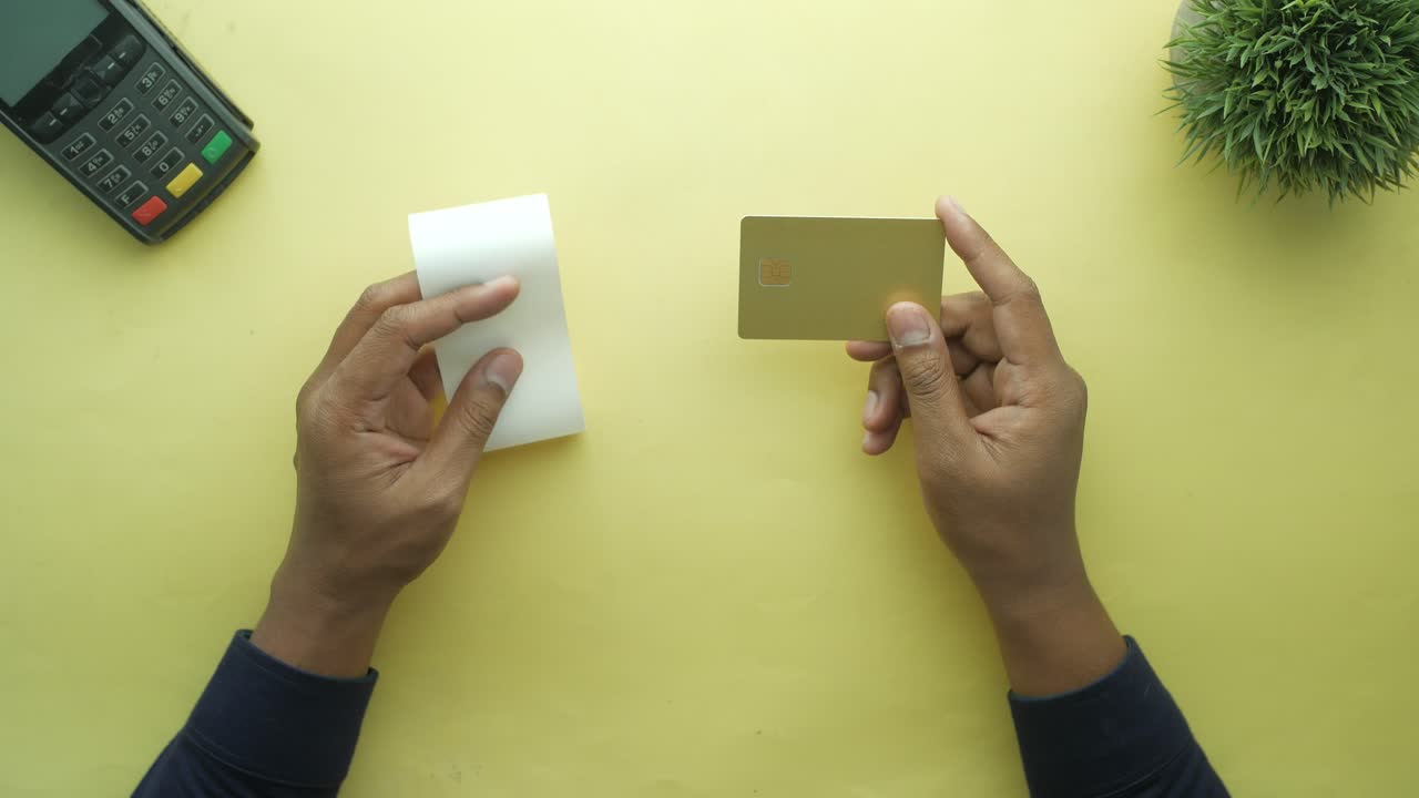 с кредитной картой и длинными рулонами бумаги ,