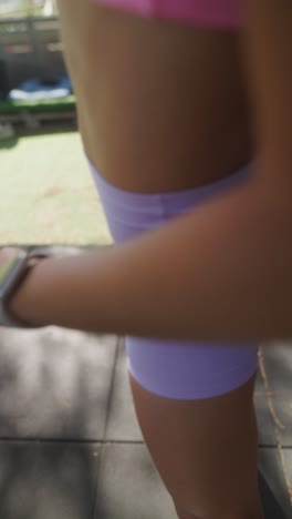 young woman in fitness attire outdoors