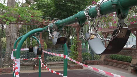 a locked swing play is seen at a closed public playground to the covid-19 coronavirus outbreak and restrictions in hong kong